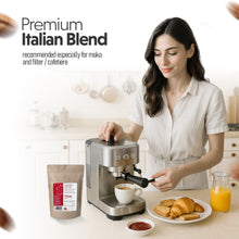 Woman making coffee using a espresso machine with a plate of pastries and juice in the background.