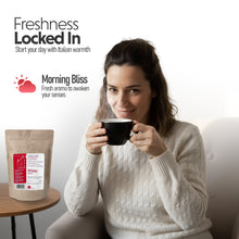 Woman holding a coffee cup with Si Sogno Milano ground coffee in the background