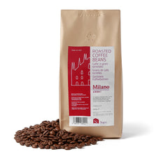 Roasted coffee beans with Milano red label on a white background